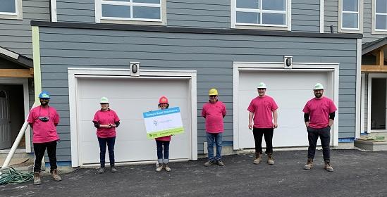 Glass 3 Enterprises staff stand outside a habitat for humanity project